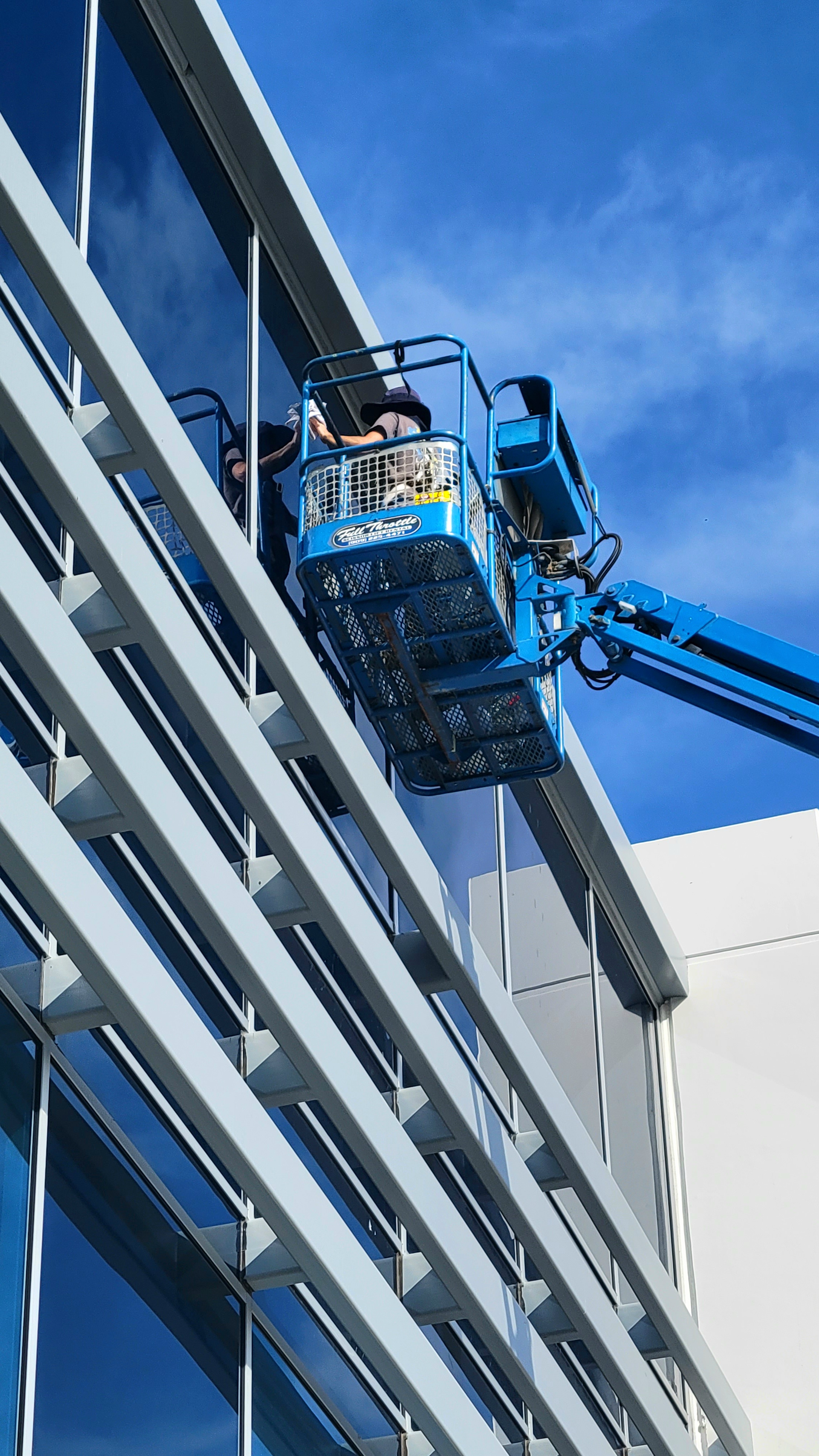construction clean on a building in Corona, CA with a 65 feet boom lift.