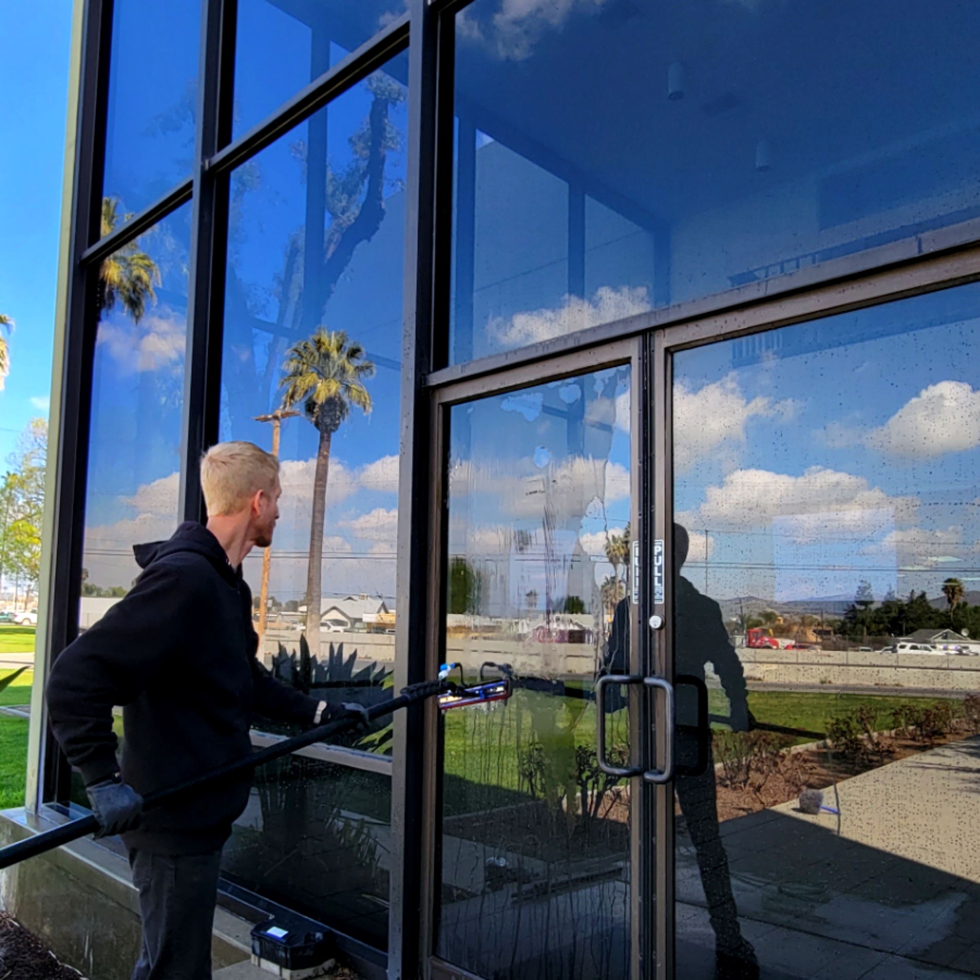 Zacch Boyes cleaning windows in Riverside, CA.